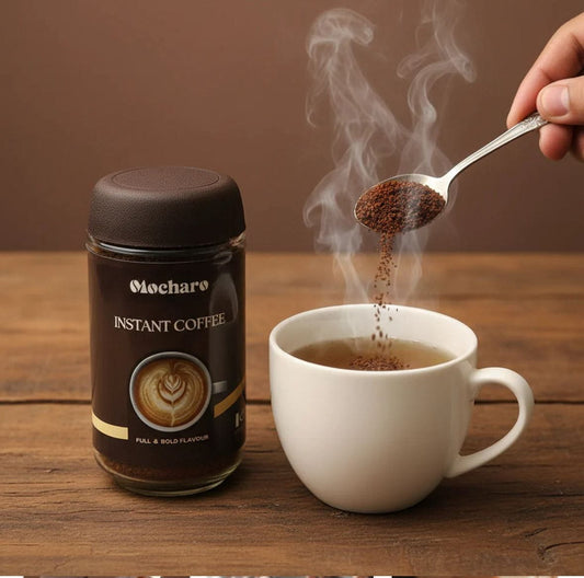 Mocharo Instant Coffee granules being spooned into steaming white mug beside full jar on wooden table